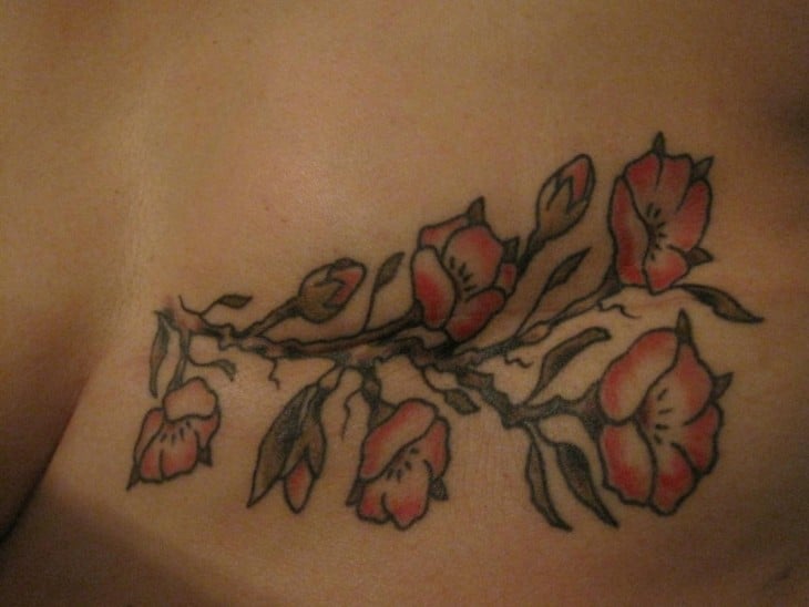 Tatuaje de flores sobre la cicatriz de una mujer que padeció cáncer de mama 