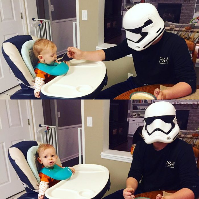 hombre con máscara de star wars alimentando a su hijo